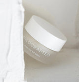 White jar of Wildcrafted bioactive eye serum on a light background