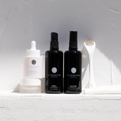 Wildcrafted skincare products on a white surface with a neutral background